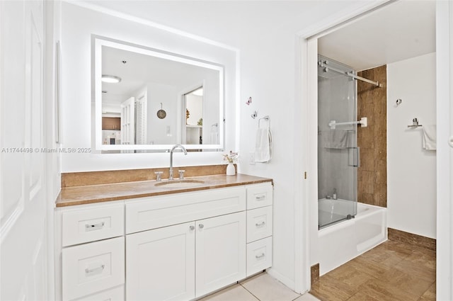 bathroom featuring vanity and shower / bath combination with glass door