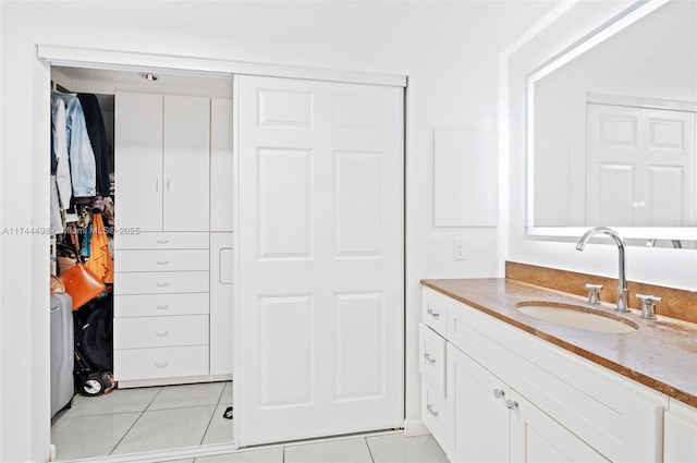 bathroom with tile patterned flooring and vanity