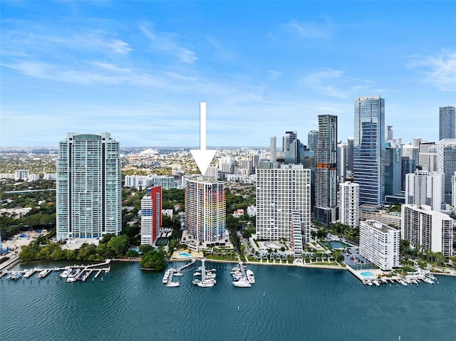 birds eye view of property with a view of city and a water view