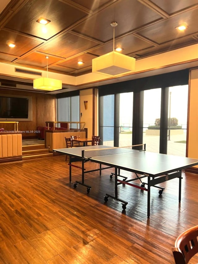 playroom featuring wood finished floors and coffered ceiling