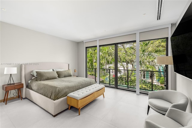 bedroom with expansive windows, access to outside, and multiple windows