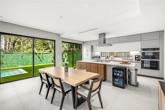 dining area with a wealth of natural light and wine cooler