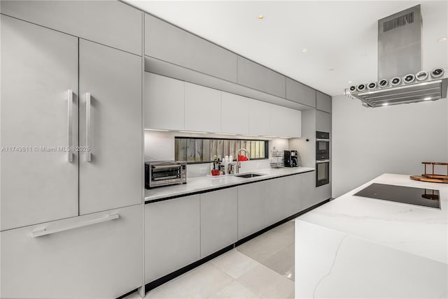 kitchen with a toaster, double wall oven, exhaust hood, a sink, and black electric cooktop