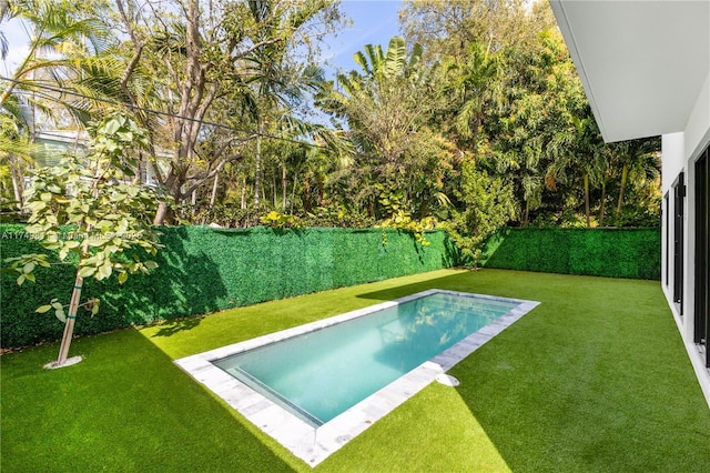 view of pool with a lawn, a fenced backyard, and a fenced in pool