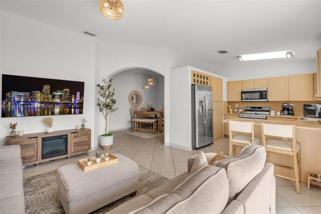 15010 SW 178th Ter, Miami, FL 33187 - living room featuring light tile patterned floors, arched walkways, and visible vents