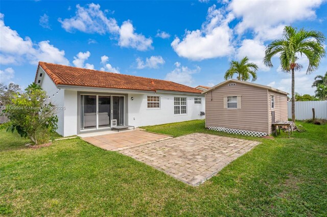 15010 SW 178th Ter, Miami, FL 33187 - rear view of property featuring a lawn, a tile roof, fence, a patio area, and stucco siding