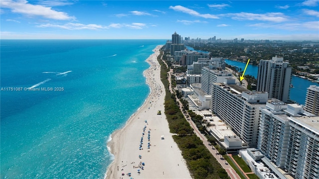 birds eye view of property with a water view, a view of the beach, and a city view