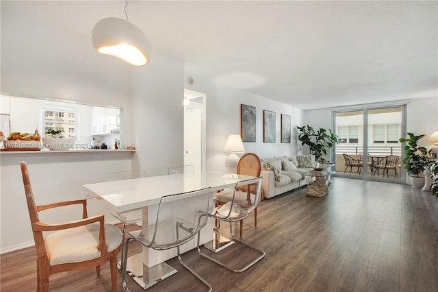 dining space with wood finished floors