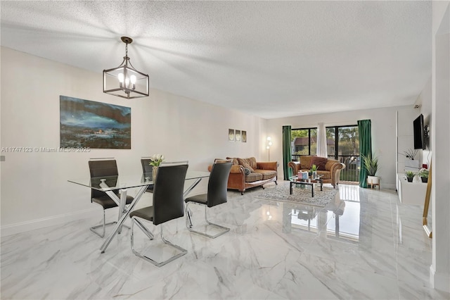 dining area with marble finish floor, baseboards, a textured ceiling, and an inviting chandelier