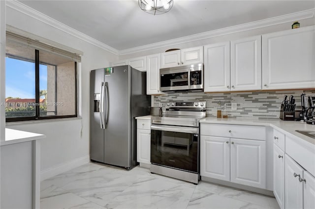 kitchen featuring white cabinets, light countertops, ornamental molding, appliances with stainless steel finishes, and decorative backsplash