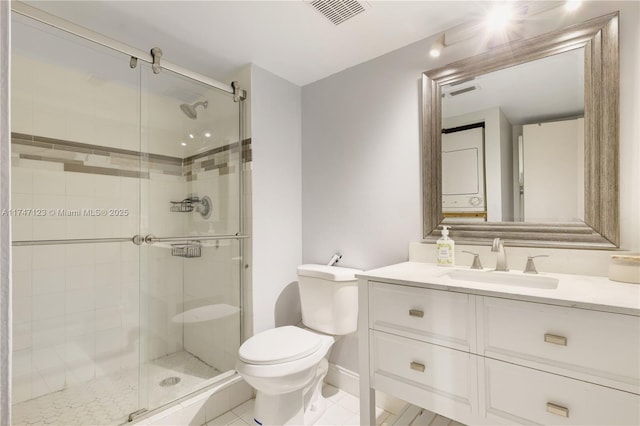 bathroom with toilet, a stall shower, vanity, and visible vents