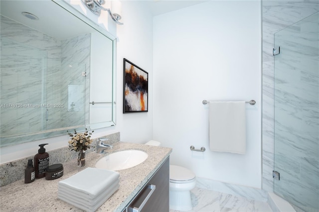 bathroom featuring marble finish floor, vanity, a marble finish shower, and toilet