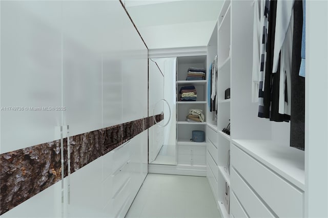 walk in closet featuring light tile patterned floors