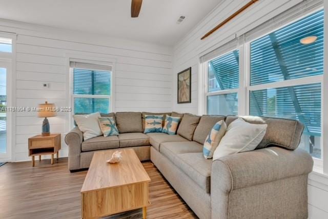 living area with ceiling fan and light wood-style flooring