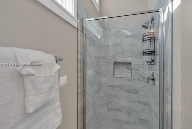 bathroom with a marble finish shower