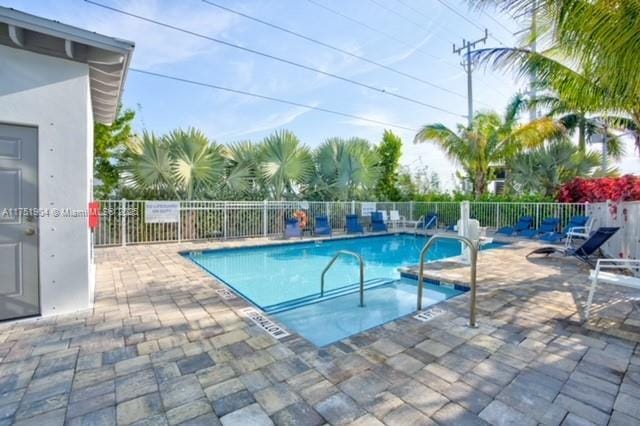 community pool featuring fence and a patio