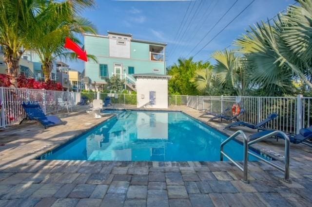 pool featuring a patio area and fence