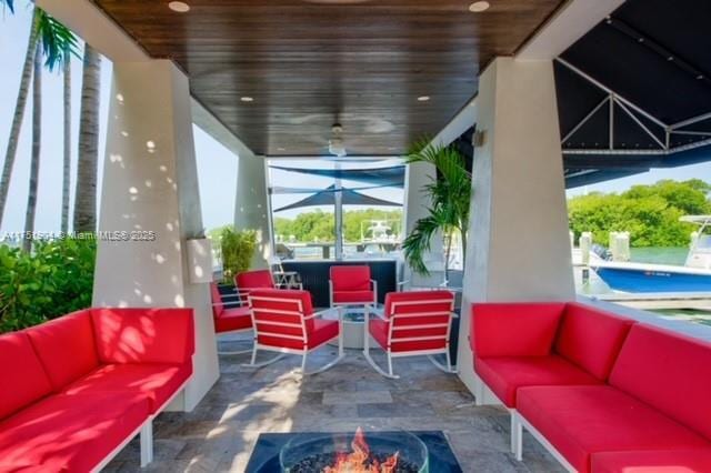 exterior space with an outdoor living space with a fire pit