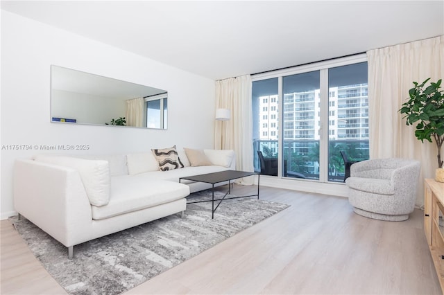 living room featuring expansive windows and wood finished floors