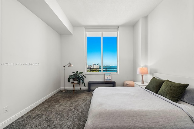 carpeted bedroom featuring baseboards