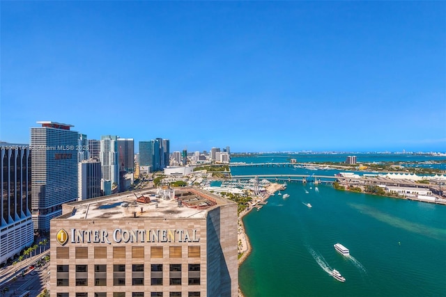 birds eye view of property with a view of city and a water view