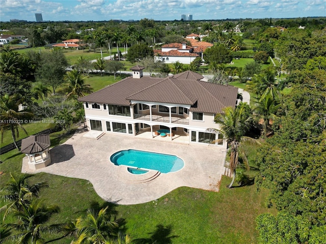 view of pool with a pool with connected hot tub, a fenced backyard, a patio, and a lawn