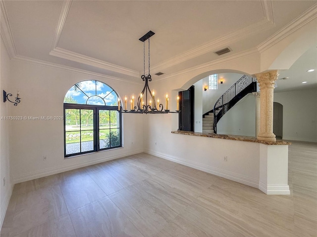 unfurnished room featuring visible vents, a tray ceiling, baseboards, and ornamental molding