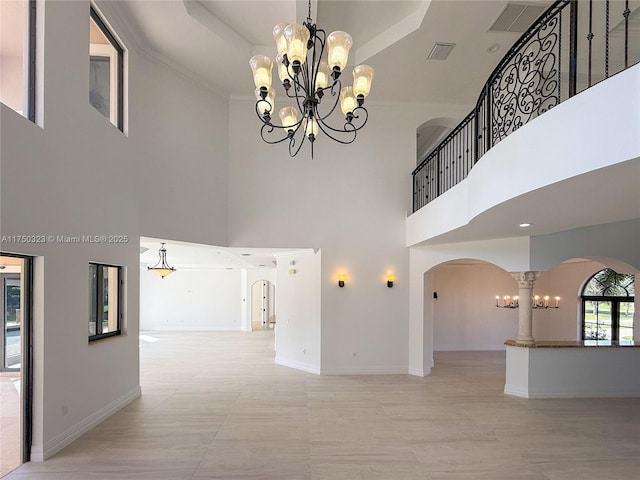 interior space featuring arched walkways, baseboards, and an inviting chandelier