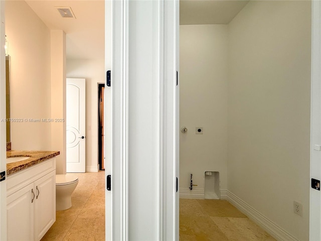 bathroom with baseboards, visible vents, vanity, and toilet