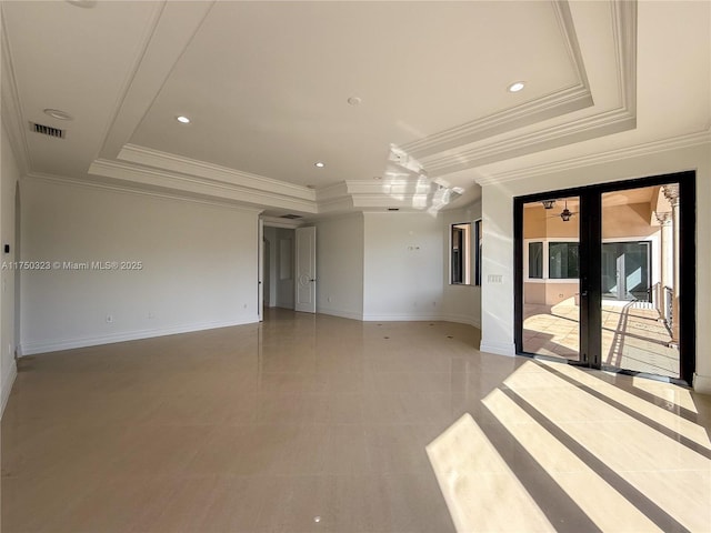 unfurnished room featuring a tray ceiling, recessed lighting, visible vents, and baseboards