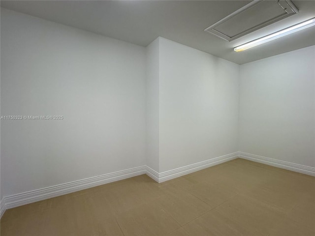 empty room featuring baseboards