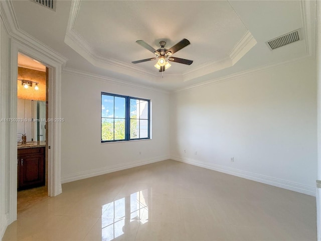 unfurnished bedroom featuring a tray ceiling, light tile patterned floors, visible vents, ornamental molding, and baseboards