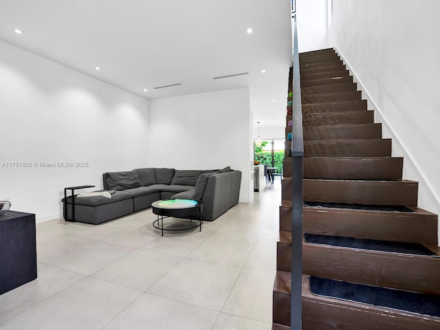 tiled living room with stairs and recessed lighting