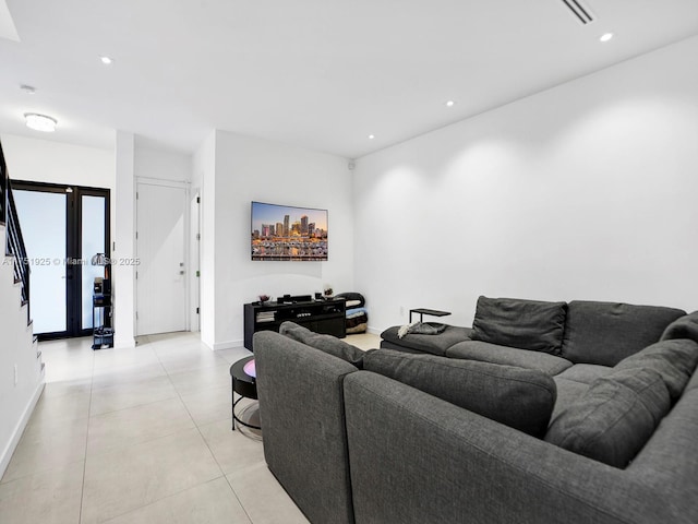 living area with light tile patterned floors, visible vents, baseboards, and recessed lighting