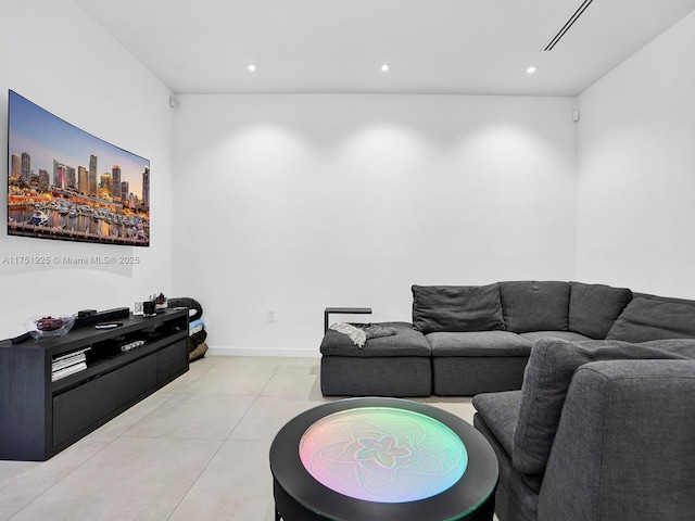 living area featuring light tile patterned floors, baseboards, and recessed lighting