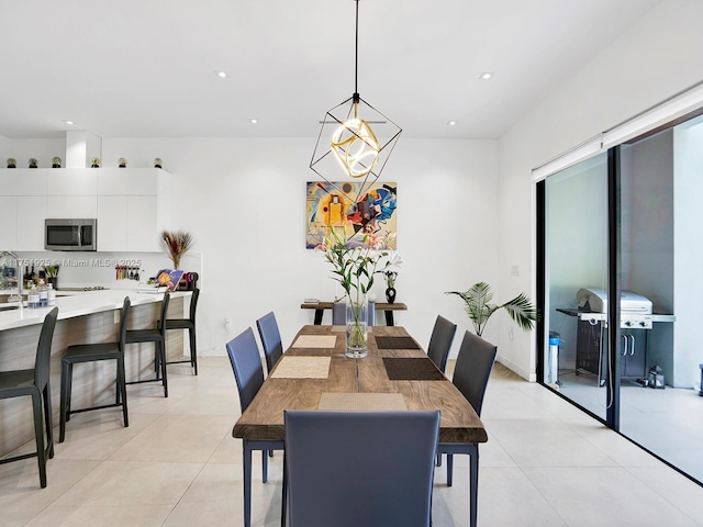 dining space with light tile patterned floors, an inviting chandelier, and recessed lighting