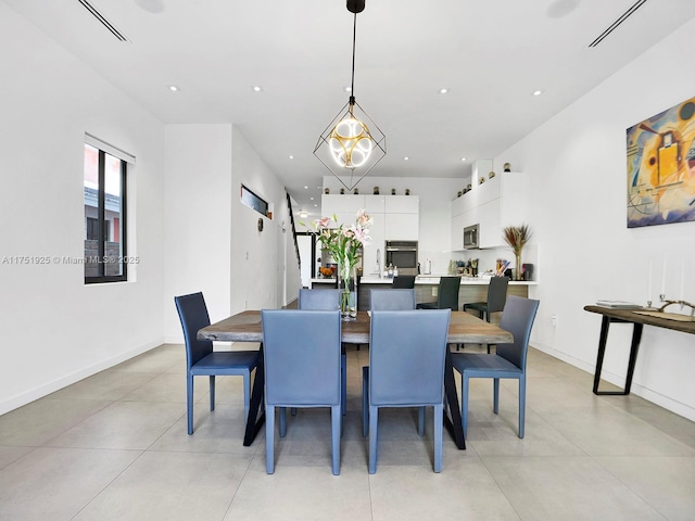 dining area featuring recessed lighting and baseboards