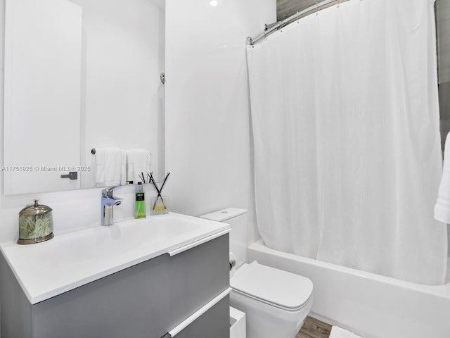 bathroom with wood finished floors, vanity, toilet, and shower / bathtub combination with curtain