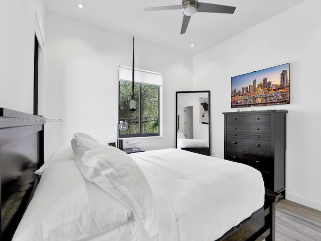 bedroom with light wood-type flooring, ceiling fan, baseboards, and recessed lighting