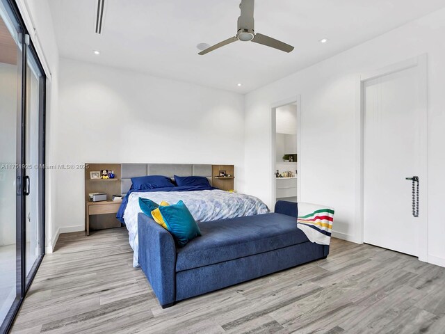 bedroom featuring a ceiling fan, recessed lighting, ensuite bath, and wood finished floors