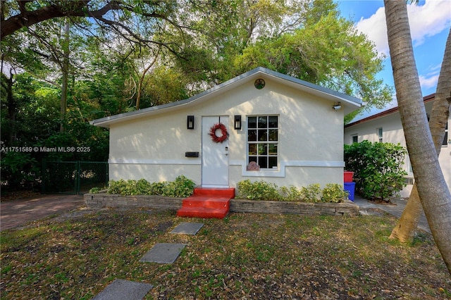 view of front of home featuring fence and stucco siding