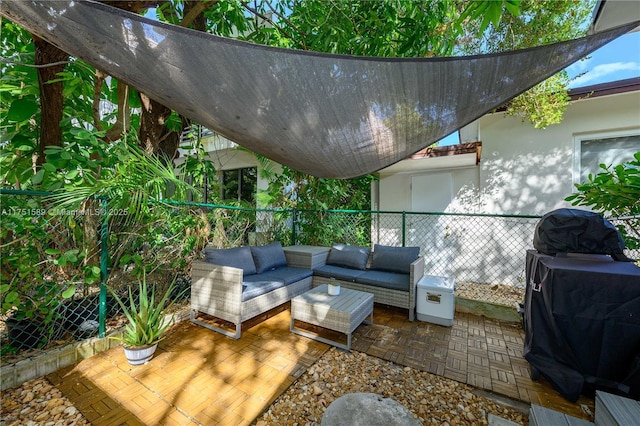 deck with fence, an outdoor hangout area, area for grilling, and a patio