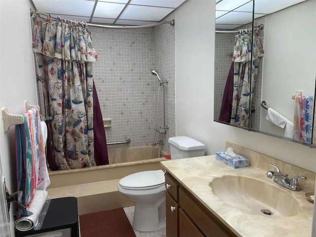 full bathroom with toilet, a paneled ceiling, and vanity