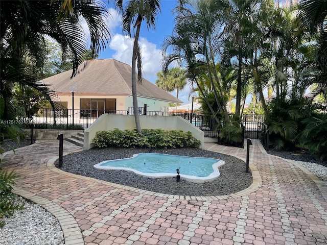 view of swimming pool with fence