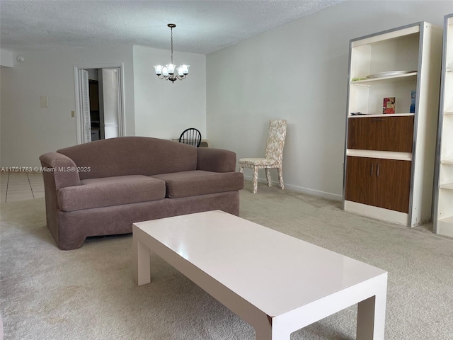 living area with light carpet, a textured ceiling, baseboards, and a notable chandelier