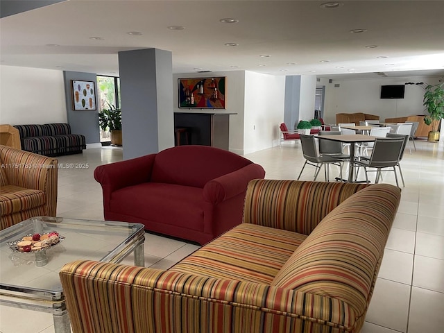 living area with recessed lighting and light tile patterned flooring