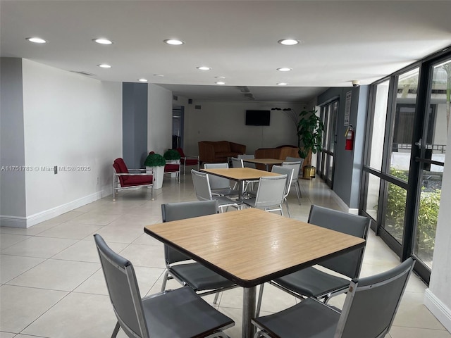 dining space featuring light tile patterned floors, a wall of windows, baseboards, and recessed lighting