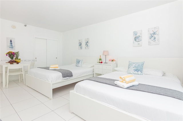 bedroom featuring a closet and light tile patterned floors