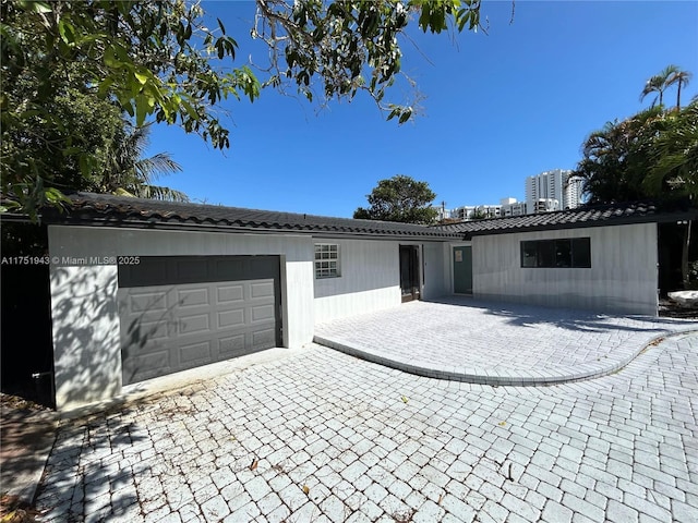 3261 Oleander Way, Lauderdale By The Sea, FL 33062 - view of front of property featuring an attached garage, a tile roof, and decorative driveway