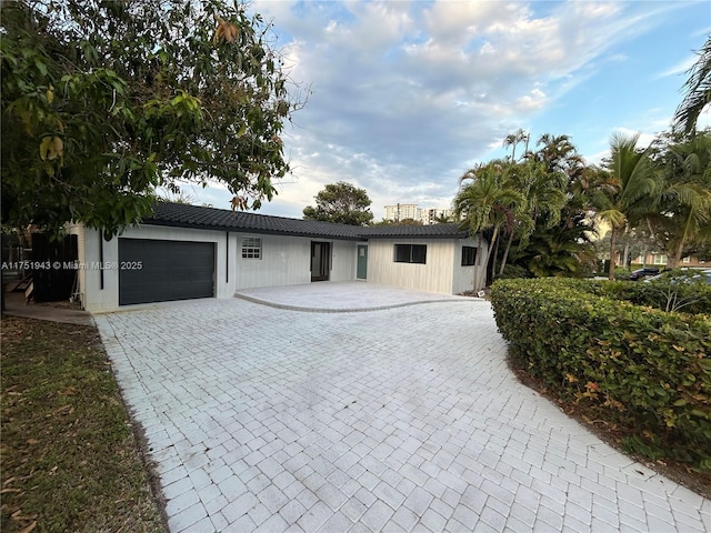 3261 Oleander Way, Lauderdale By The Sea, FL 33062 - single story home featuring a garage, decorative driveway, and a tiled roof